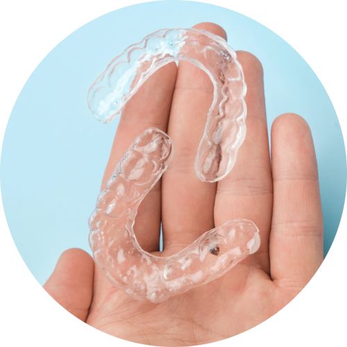 close-up-mans-hand-holding-invisible-aligners-for--JPP77YV@2x